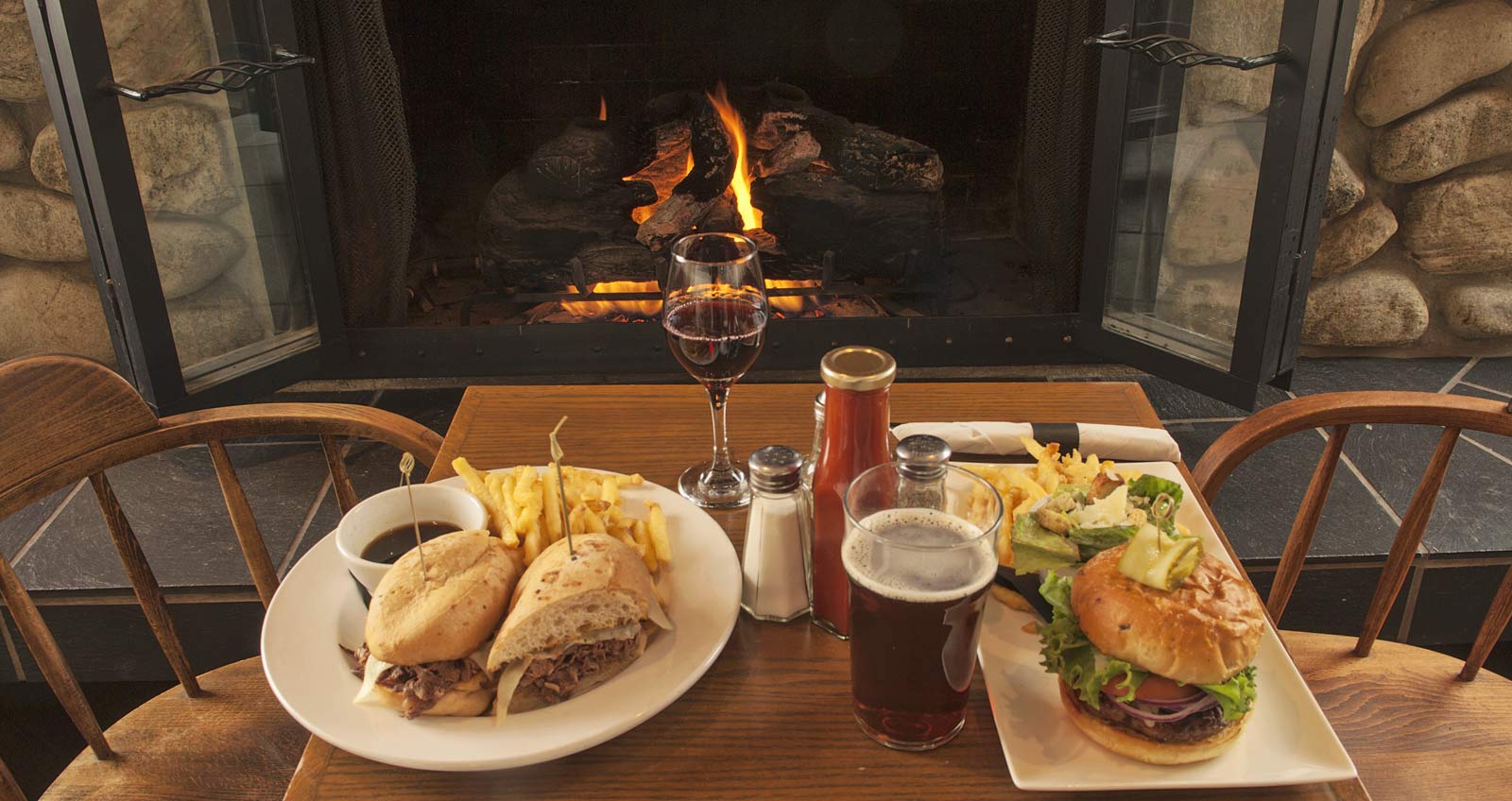 A meal by the  seating at McCulloch Station Pub with the fireplace on, omitting a lovely welcoming heat for this time of year